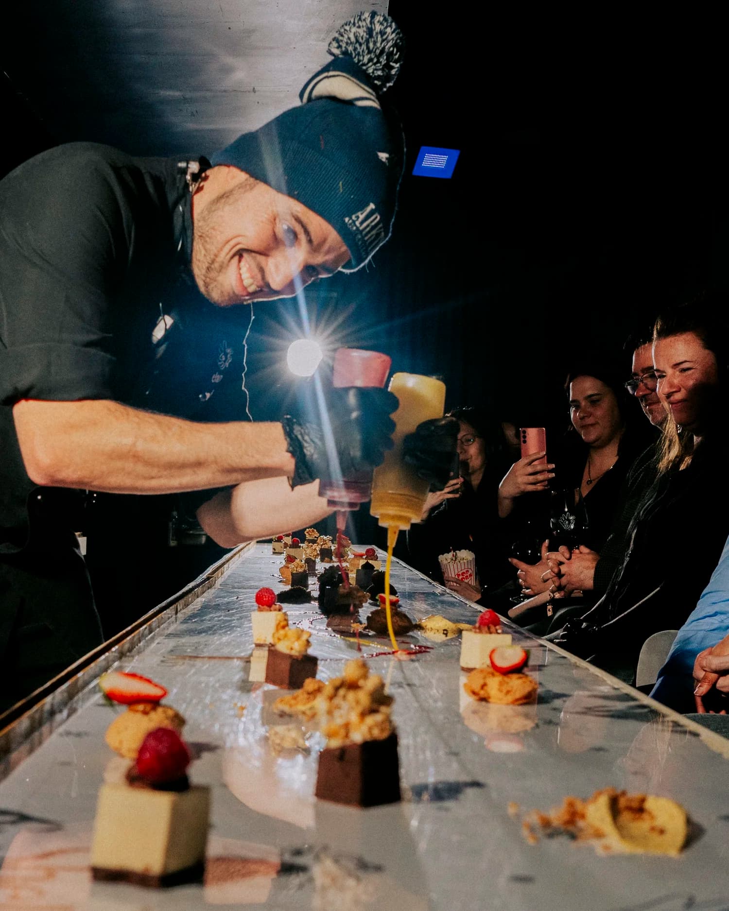 Shelanous restaurant chef plating dessert at the long table